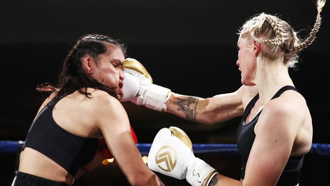 Tayla Harris lands a right hook on Janay Harding during their bout.