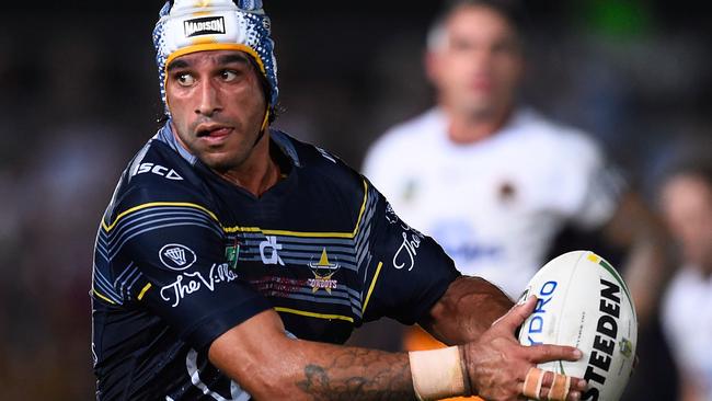 Johnathan Thurston runs the ball during a clash with the Broncos.