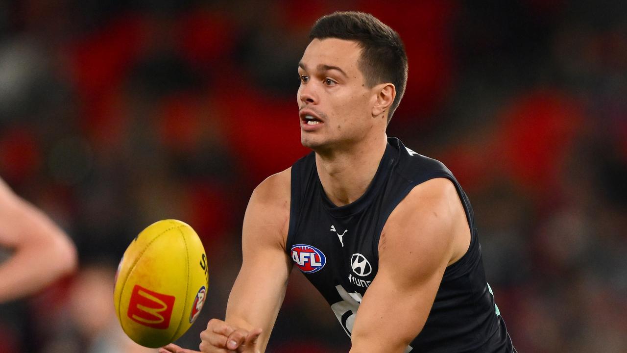 MELBOURNE, AUSTRALIA - JULY 15: Jack Silvagni of the Blues handballs during the 2023 AFL Round 18 match between the Carlton Blues and the Port Adelaide Power at Marvel Stadium on July 15, 2023 in Melbourne, Australia. (Photo by Morgan Hancock/AFL Photos via Getty Images)