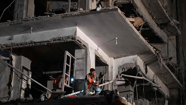 Forensic oficers check a residential building hit by a reported Israeli air strike, in the Mazzeh suburb of Damascus on Tuesday. Picture: AFP