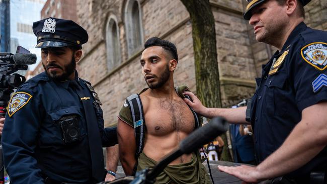 A man is detained after a scuffle as pro-Palestinian protesters rally outside the Fordham University in New York. Picture: AFP