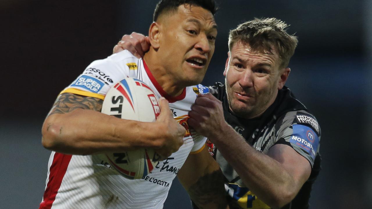 CORRECTION - Catalans Dragons' Australian full-back Israel Folau (L) powers his way during the Super League rugby match between Dragons Catalans and