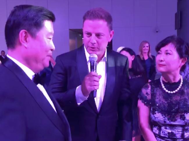 Ben Fordham talks to Yoo Chan Kim and his wife at the charity event.