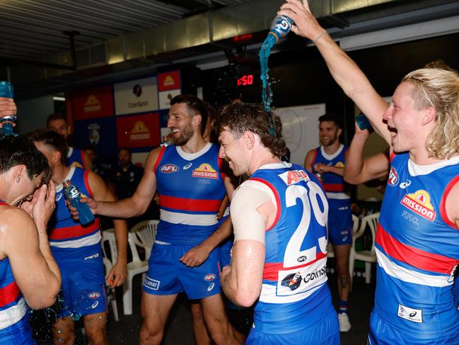 Lachlan Bramble of the Bulldogs receives a gatorade shower after his first win last week. He, alongside other half-backs Dale, Williams and Johannisen were brilliant against the Eagles. Picture: Dylan Burns/AFL Photos via Getty Images.