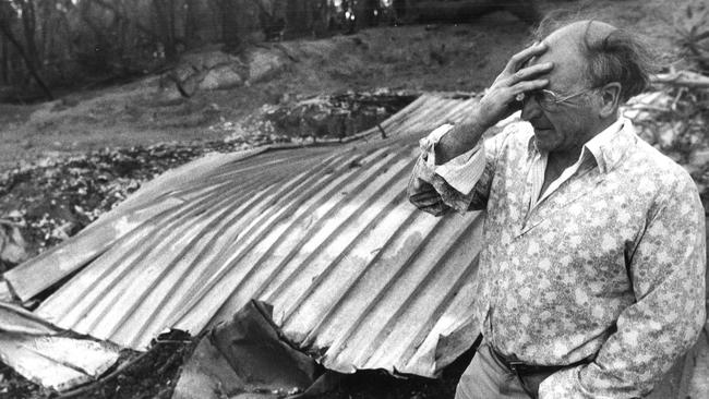 John Crook, from Belgrave, holds back the tears after seeing the remains of his charred home in the Dandenongs after the fires. Picture: Bruce Howard