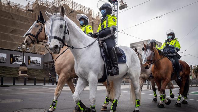 Mounted police patrol the streets where an anti-lockdown rally was planned. Picture: Jake Nowakowski