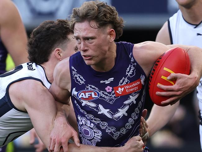 PERTH, AUSTRALIA - JULY 09: Matthew Johnson of the Dockers looks to break from a tackle by Blake Acres of the Blues during the round 17 AFL match between Fremantle Dockers and Carlton Blues at Optus Stadium, on July 09, 2023, in Perth, Australia. (Photo by Paul Kane/Getty Images)