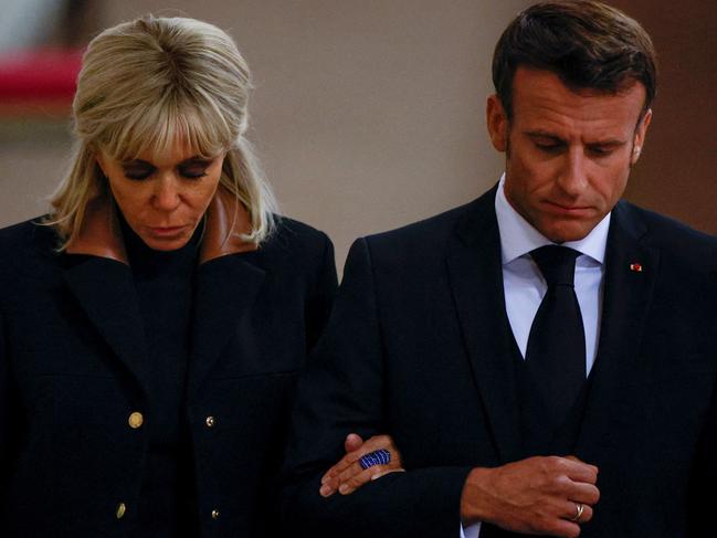 French President Emmanuel Macron (R) and First Lady Brigitte Macron (L) arrive to pay their respects to the coffin of Queen Elizabeth II. Picture: AFP.