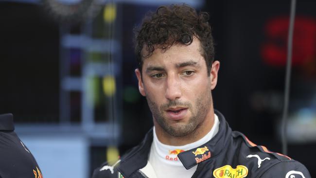 Red Bull Racing driver Daniel Ricciardo of Australia waits at walks out from garage after first practice at the Marina Bay City Circuit ahead of the Singapore Formula One Grand Prix in Singapore, Friday, Sept. 14, 2018. (AP Photo/Yong Teck Lim)
