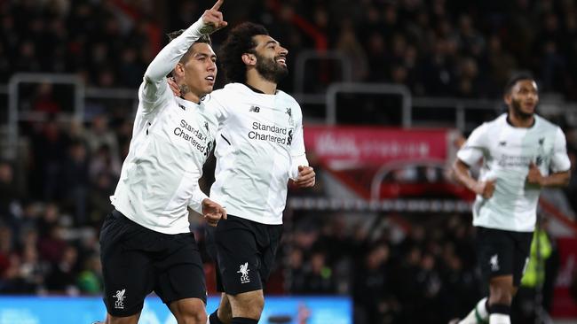 Roberto Firmino celebrates with Mohamed Salah.