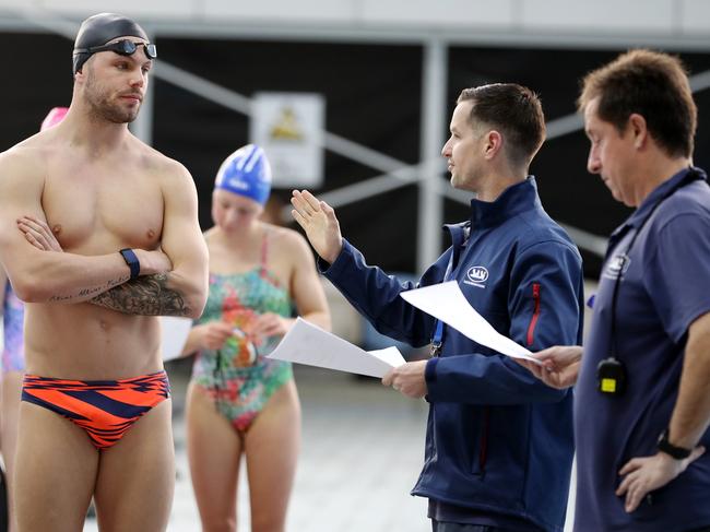 Kyle Chalmers talks to coaches Craig Stewart, centre, and Peter Bishop, right. Picture: Sarah Reed