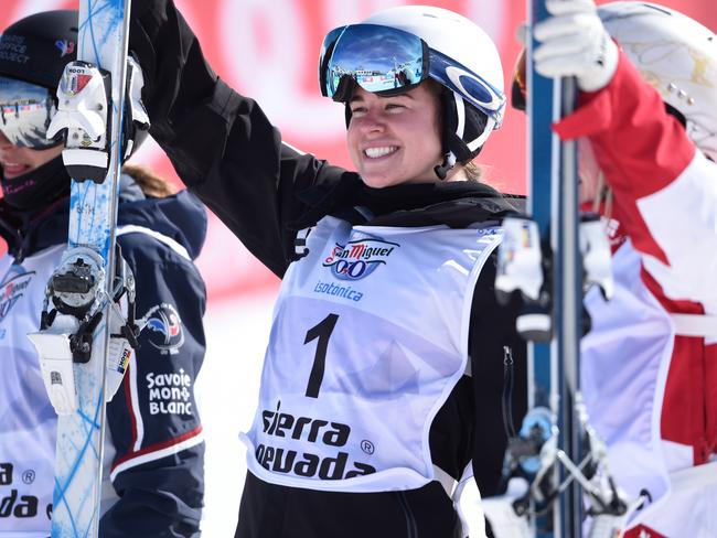 Britteny Cox, centre, after winning the gold medal at the FIS Freestyle Ski and Snowboard world championships.