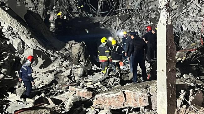 Firemen and security staff inspect the rubble of a building hit by a missile launched by Iran's Islamic Revolutionary Guard Corps in Arbil on Tuesday. Picture: AFP