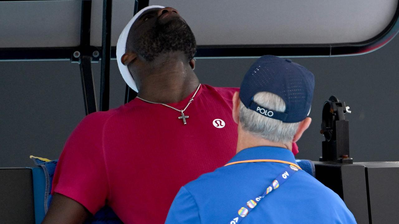 American star Frances Tiafoe received treatment after vomiting courtside during the fourth set of his five-set win over Arthur Rinderknech. Picture: Yuichi Yamazaki / AFP