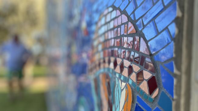 Two years in the making, 230 contributors from around the country, 100,000 pieces of tessera and an army of volunteers is what it took to bring Paul Perry's vision for the new artwork surrounding the public toilets at Archie's Beach.