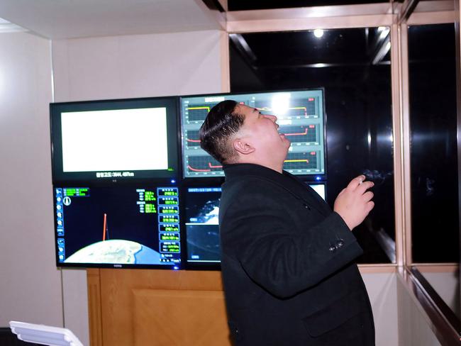 Kim Jong-un, with cigarette in hand, looks at launch of the Hwasong-15 missile. Picture: AFP/Korean Central News Agency/Korea News Service