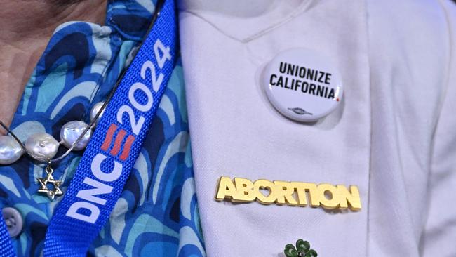 A an attendee wears a "abortion" pin on the first day of the Democratic National Convention. Picture: Robyn Beck/AFP