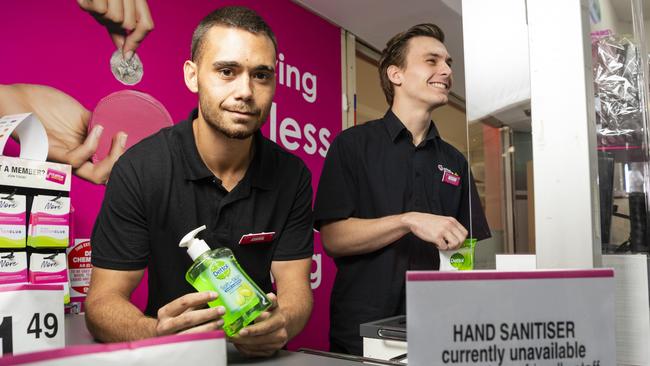 Priceline Alice Springs staff members Mitchell Rosewood and Darcy McKinnon with a sign advising customers that hand sanitiser is not available for purchase, Wednesday, February 1, 2023. Picture: Kevin Farmer