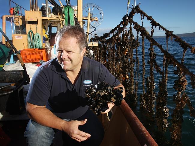 Andrew Puglisi, managing director of Kinkawooka Shellfish, aboard his boat in Boston Bay at Port Lincoln.