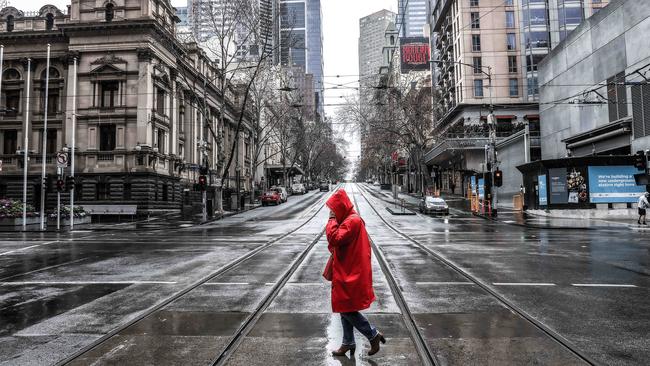 A woman crosses Collins St in Melbourne CBD during the lockdown. Picture: NCA NewsWire/Ian Currie