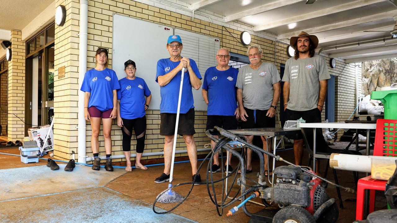 Ellis Beach Surf Lifesaving Club members Erin Buckley, Skye Boothe, Mick Roberts, Dave Donnelly, Graeme Boothe and Hugo Doessel have help clean up after flooding rain tore through the clubhouse on Sunday. Picture: Brendan Radke