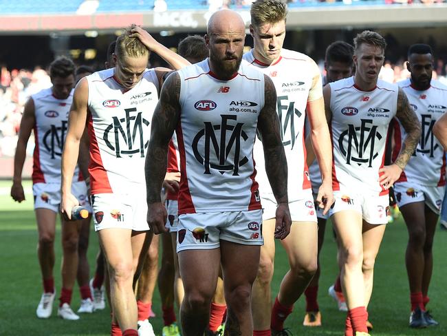 Melbourne captain Nathan Jones leads his team off the field after the shock loss.