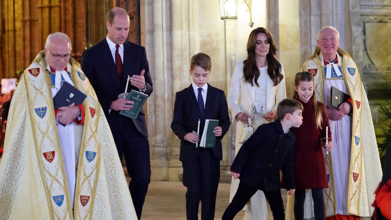 Prince Louis of Wales blew out his older sister’s candle during a Christmas carols service at Westminster Abbey. Picture: Chris Jackson / Pool / AFP