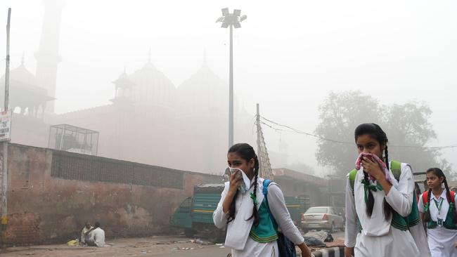 Indian school girls covering their faces amid heavy smog of New Delhi. Picture: AFP