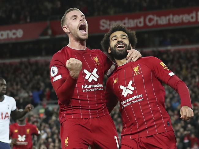 Liverpool's Mohamed Salah, right, celebrates with his teammate Jordan Henderson after scoring his side's second goal during the English Premier League soccer match between Liverpool and Tottenham Hotspur at Anfield stadium in Liverpool, England, Sunday, Oct. 27, 2019. (AP Photo/Jon Super)