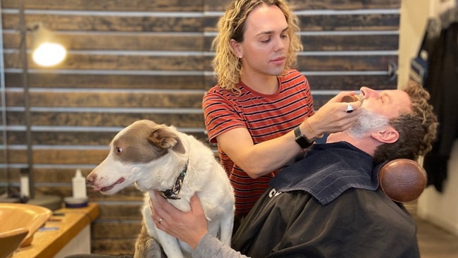 Customer Jack Post with dog Luna at Chapel St's The Bearded Man barber. Picture: Supplied.