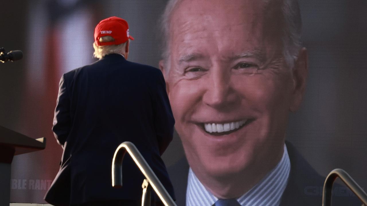 Donald Trump looking at Joe Biden laughing. Joe Raedle/Getty Images/AFP