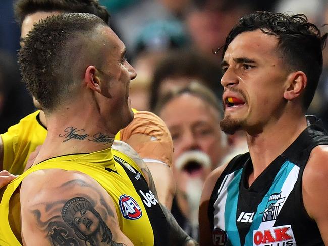 ADELAIDE, AUSTRALIA - JULY 01: Travis Boak, Sam Powell-Pepper of the Power and Dustin Martin of the Tigers wrestle during the round 15 AFL match between the Port Adelaide Power and the Richmond Tigers at Adelaide Oval on July 1, 2017 in Adelaide, Australia.  (Photo by Daniel Kalisz/Getty Images)