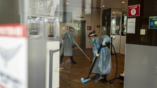 Cleaners are seen wearing full PPE while working at the disinfection of the Holiday Inn hotel on February 10, 2021 in Melbourne, (Photo by Diego Fedele/Getty Images)