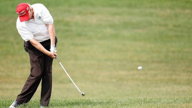 Trump plays a shot on the first hole during the pro-am prior to the LIV Golf Invitational. Picture: Cliff Hawkins/Getty Images/AFP.