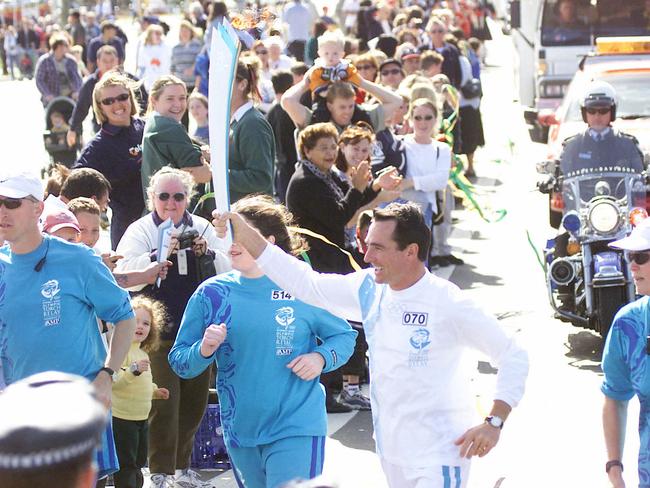 Olympic Torch Relay Day 89, Penrith to Bowral. Torchbearer Pat Farmer carrying flame on 04 Sep 2000.