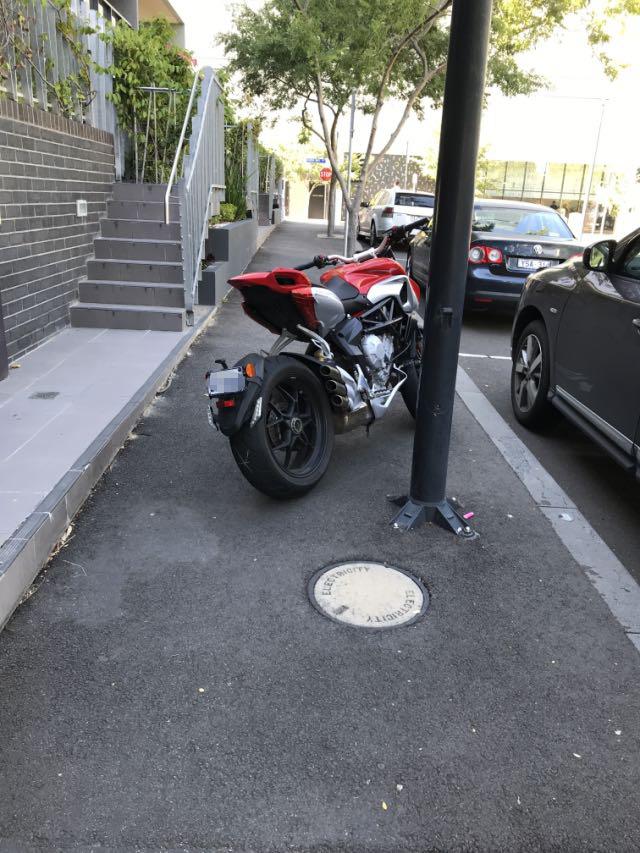 A motorcycle makes access difficult in Geographe St, Docklands. Picture: Snap Send Solve