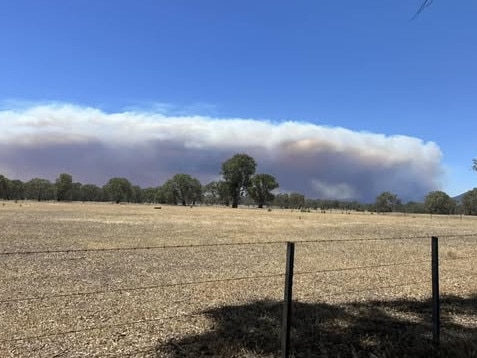 Smoke fills the sky as the fire burns in ‘difficult terrain’. Picture: Mandy Straw