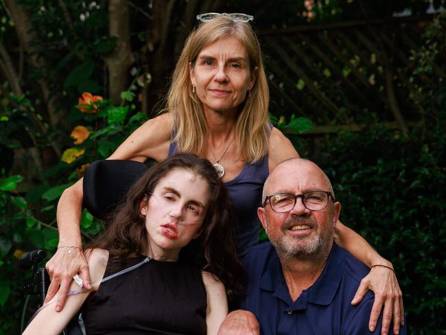 Daily Telegraph. 03, December, 2024.Monica Andersson and Grant Lawrence with their daughter Jessica Lawrence, 25, in Mosman, today. Jessica is suffering from neurofibromatosis type 2, a disease that sees tumours grow on nerves. Picture: Justin Lloyd.