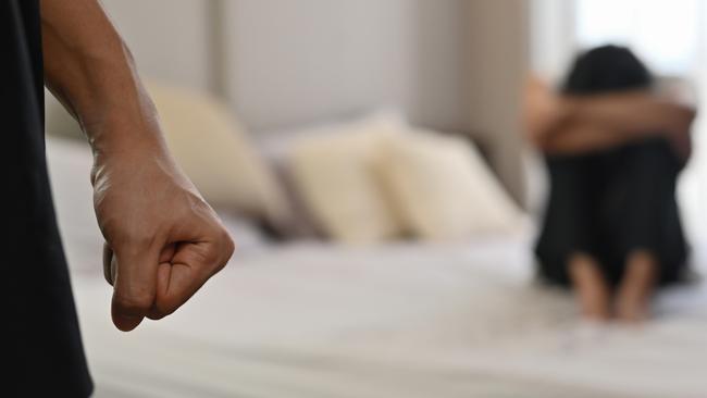 istock generic:  woman, abuse, DV, domestic violence, harassment, sexual harassment.   Selective focus on the fist male with crying man sits on a bed as the background, Violence, Love and relationships, Gay couple, sexual harassment concept. . Picture: istock