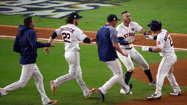 Alex Bregman, No 2, of the Houston Astros celebrates with teammates after hitting a game-winning single against the Los Angeles Dodgers in game five of the World Series. Picture: Getty Images.