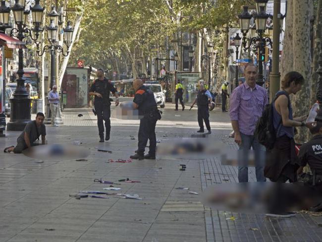 Police officers attend injured people after a van crashes into pedestrians in Las Ramblas. Picture: EFE News Agency/Alamy Live News