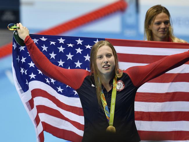 United States' gold medal winner Lilly King celebrates with her country's flag after the women's 100-meter breaststroke )