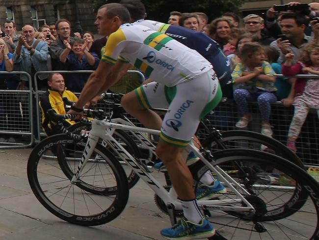 LEEDS, ENGLAND - JULY 03: Australian National Road Champion Simon Gerrans (R) and his Orica-GreenEDGE teammates are greeted by supporters as they ride through Millenium Square enroute to the Team Presentation prior to the 2014 Le Tour de France on July 3, 2014 in Leeds, United Kingdom. (Photo by Doug Pensinger/Getty Images)