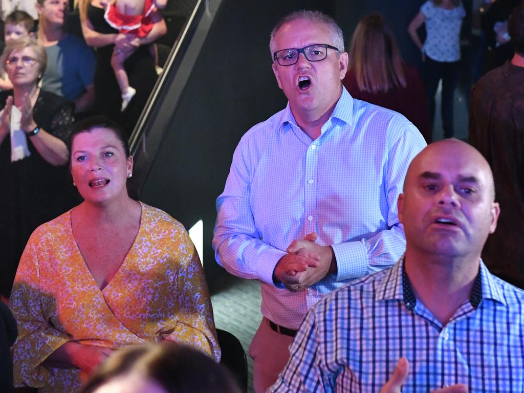 Prime Minister Scott Morrison and wife Jenny sing during an Easter Sunday service at his Horizon Church at Sutherland in Sydney. Picture: Mick Tsikas