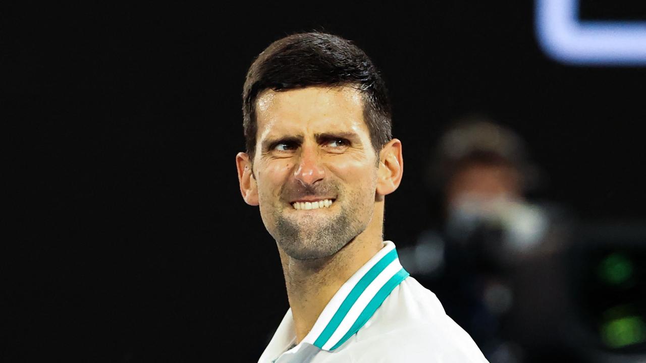 TOPSHOT - Serbia's Novak Djokovic celebrates winning against Russia's Aslan Karatsev during their men's singles semi-final match on day eleven of the Australian Open tennis tournament in Melbourne on February 18, 2021. (Photo by David Gray / AFP) / -- IMAGE RESTRICTED TO EDITORIAL USE - STRICTLY NO COMMERCIAL USE --