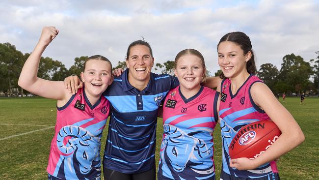 Crows AFLW star Chelsea Randall with (left to right) Aayla Walker, 12, Abbey Bates, 11, and Violet Tulloch, 11, of the Glenunga Football Club, where Chelsea has joined as a junior girls football leader and mentor for 2024. Picture: Matt Loxton