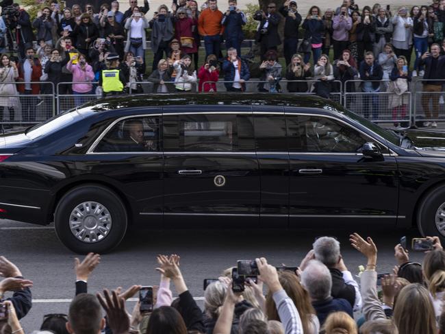 US President Joe Biden and First Lady Jill Biden wave to the crowd from 'The Beast' as they leave Westminster Hall after paying their respects at Queen Elizabeth’s funeral in 2022. Picture: Getty Images.