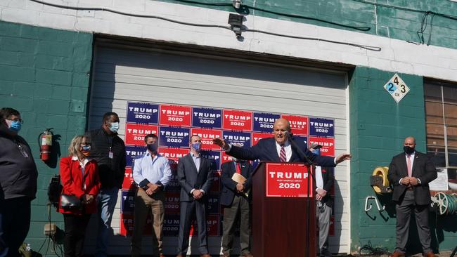 Rudy Giuliani, speaks at a news conference in the parking lot of the Four Seasons Landscaping company. Picture: AFP.