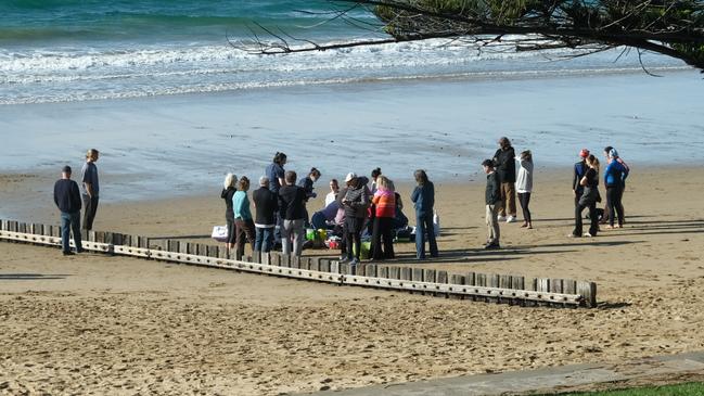 Paramedics attend an accident at Torquay main beach on Saturday.