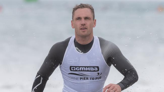 Joel Selwood emerges from the surf after completing the Lorne Pier to Pub race in Lorne.